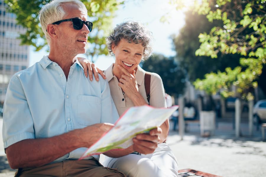 Senior couple reading a city map during outing